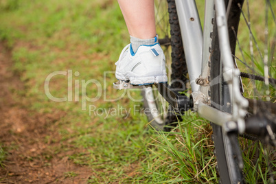 Close up view of woman pedaling on mountain bike