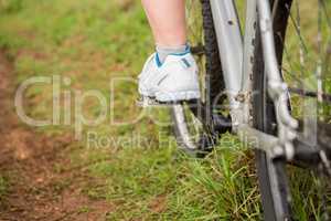 Close up view of woman pedaling on mountain bike