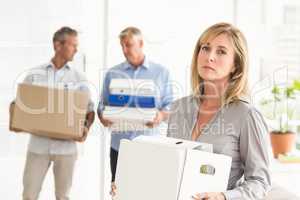 Disappointed casual businesswoman with carton