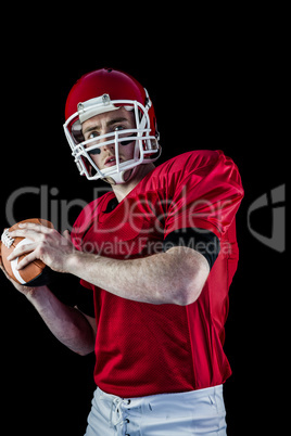 Portrait of american football player being about to throw footba