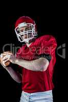 Portrait of american football player being about to throw footba