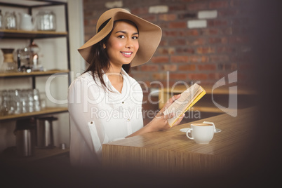 Beautiful businesswoman reading a book