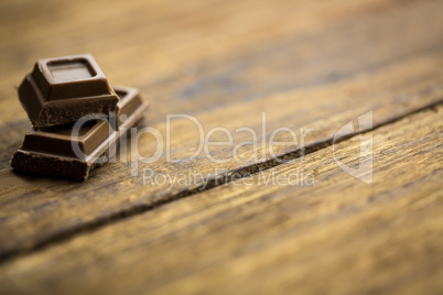 Pieces of chocolate on a wooden table