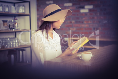 Beautiful businesswoman reading a book