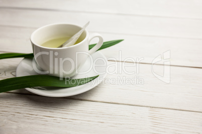 Cup of herbal tea on table