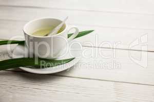 Cup of herbal tea on table