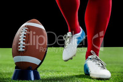 American football player being about to kick football