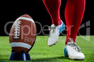 American football player being about to kick football