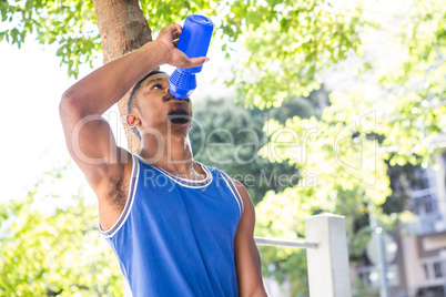 An handsome athlete drinking water