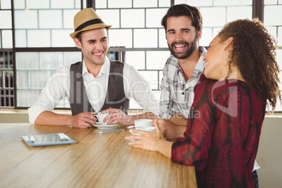 Happy friends discussing together