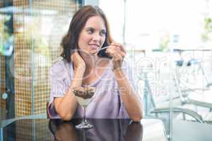 Pretty brunette enjoying chocolate dessert