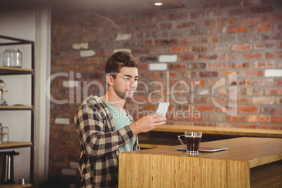 Hipster having coffee and using smartphone