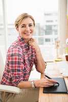 Smiling casual designer working with digitizer