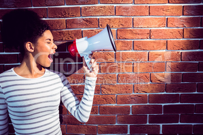 Young woman using her megaphone in the light