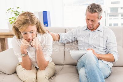 Concerned therapist comforting female patient