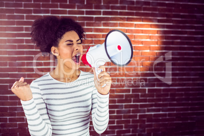 Young woman using her megaphone in the light