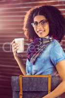 Smiling attractive hipster with felt bag and coffee