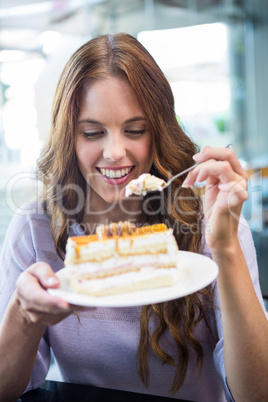 Pretty brunette enjoying a cake