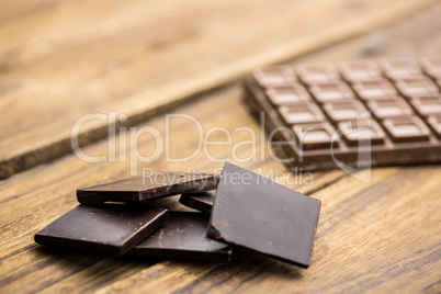 Pieces of chocolate on a wooden table