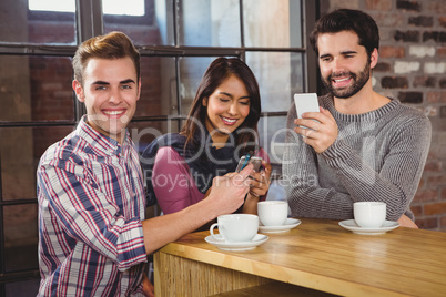 Group of friends looking at their smartphone
