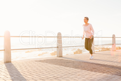Sporty woman jogging at promenade