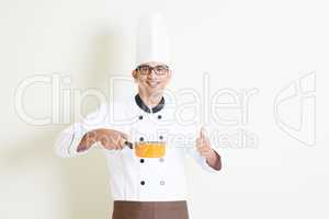 Indian male chef in uniform cooking and thumb up