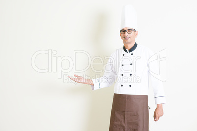 Indian male chef in uniform welcoming