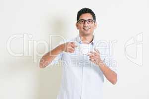 Casual business Indian male drinking coffee