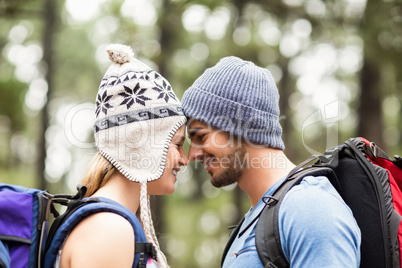 Young happy hiker couple touching foreheads