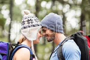 Young happy hiker couple touching foreheads