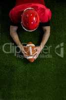 American football player reaching football