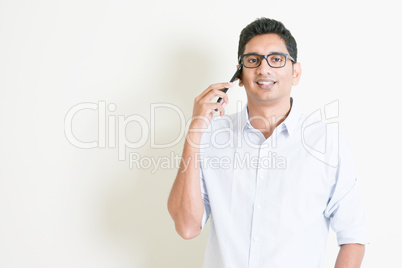 Casual business Indian male calling on smartphone