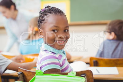 Pupil smiling at camera during class