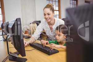 Teacher showing student how to use a computer