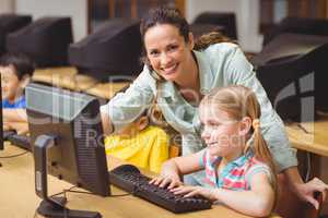 Cute pupils in computer class with teacher