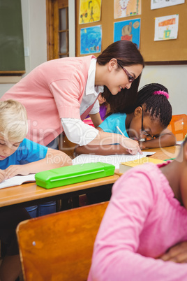 Smiling teacher helping a student