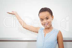 Pupil raising hand to blackboard