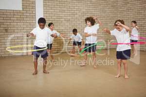 Students using some hula hoops