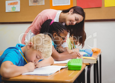 Smiling teacher helping a student