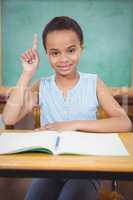 Smiling student with a rasied hand