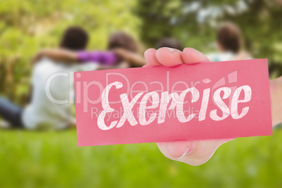 Exercise against children sitting with arms around at park