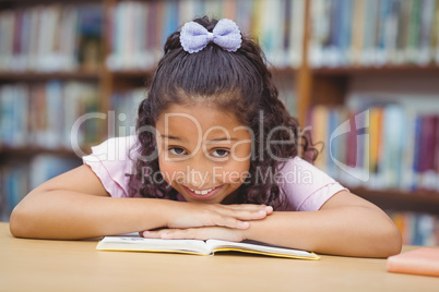 Pupil smiling at camera in library