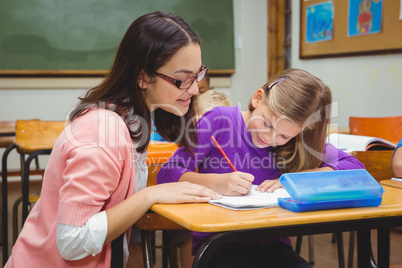 Happy teacher helping her students