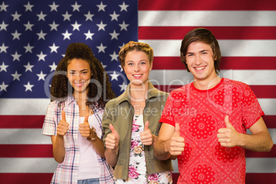 Composite image of college students gesturing thumbs up in libra