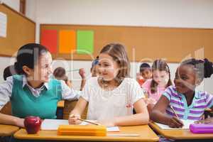 Teacher helping pupils during class