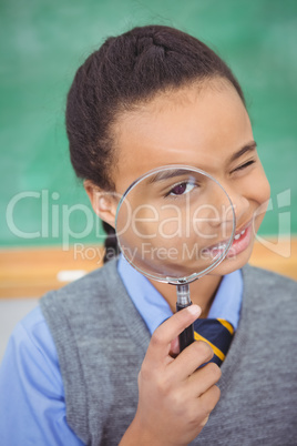 Curious student using a magnifying glass