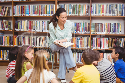 Pupils and teacher in the library using computer