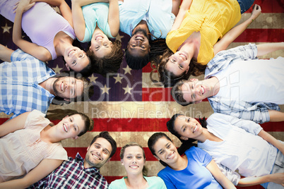 Composite image of happy friends lying in circle