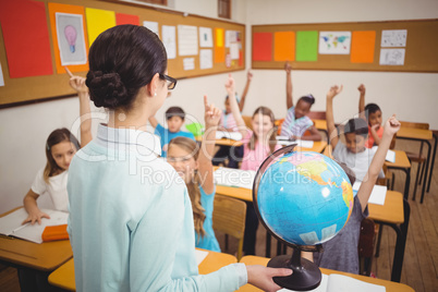 Teacher showing pupils a globe