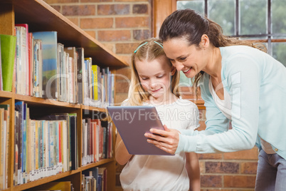 Teacher helping a student use a tablet